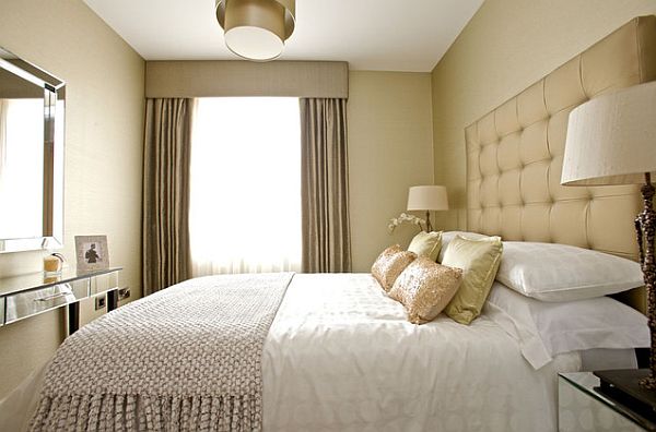 Feminine-bedroom-design-with-neutral-colour-scheme-and-quilted-headboard