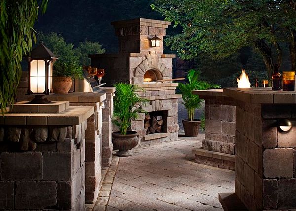 outdoor kitchen with pizza oven and stone tables