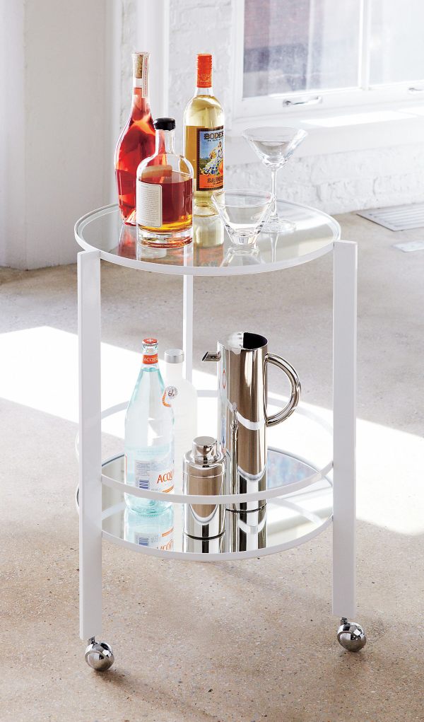 A bar cart with mirrored discs