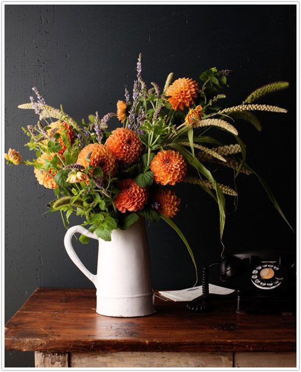 A fall centerpiece in a pitcher vase