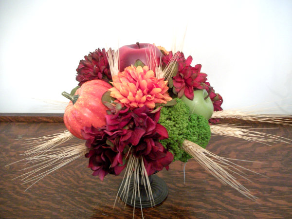 A hydrangea, fruit and wheat centerpiece