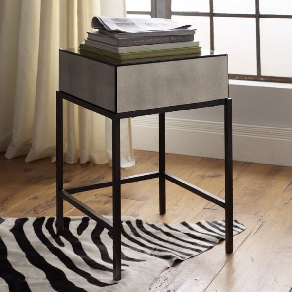 A mirrored nightstand