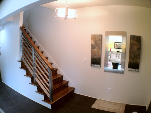 A stainless steel handrail with a wooden top