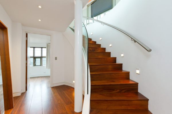 A-staircase-with-a-metal-handle-and-a-glass-wall
