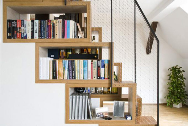 Beautiful book shelf that matches the design of the stairs