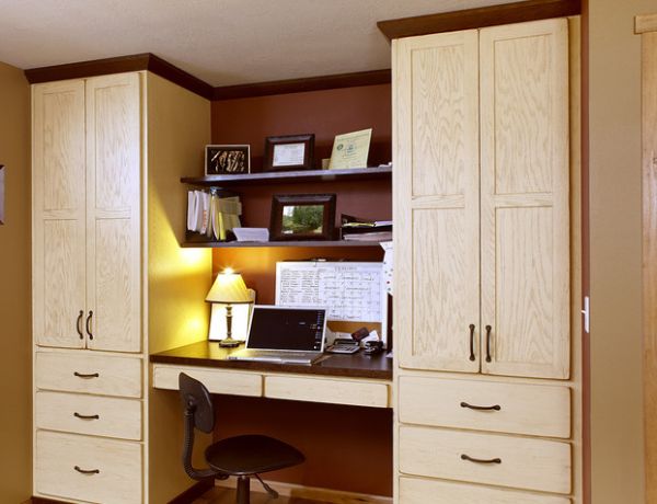 Cozy office space nestled between large red oak showplace cabinets