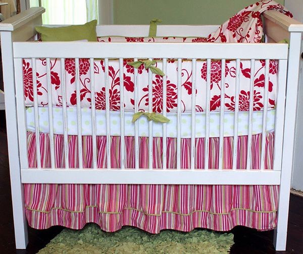 Dazzling red floral pattern with tropical flair adorn this baby bedding set