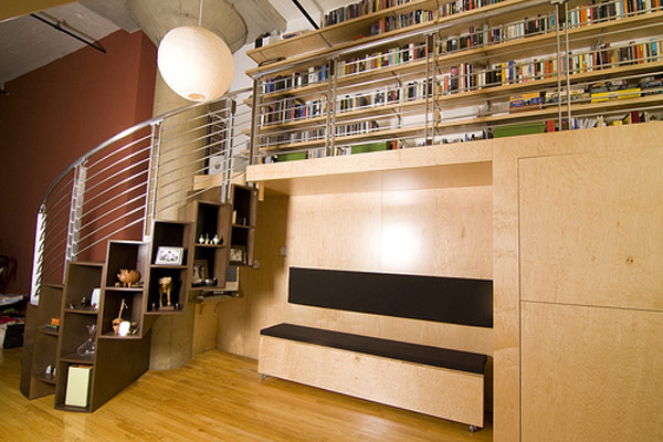 Large storage shelf space under modern metallic stairs