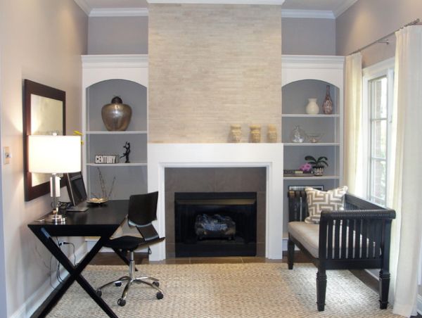 Minimalist work station in beautiful and sleek black next to a fireplace