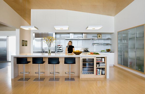 Modern kitchen with glass unit and light wood flooring