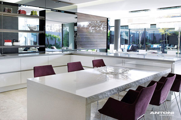 Opulent-modern-home-in-Houghton-modern-kitchen-decor-with-white-table-and-purple-chairs