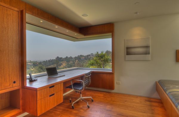 Panoramic window gives this home office a great view of the outdoors