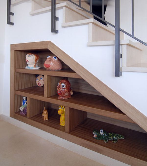 Storage space under stairs with eclectic decor