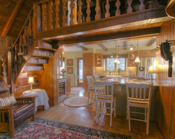 Stylish wooden bookshelf under the stairs