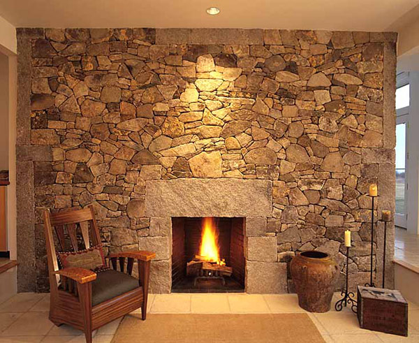 Unassuming Fireplace complemented by a stone wall