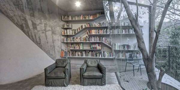 Unusual home library employs gray and glass