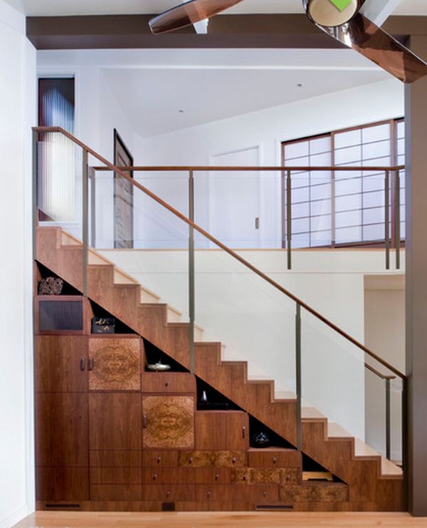 Valuable and artistic storage shelves under wooden staircase