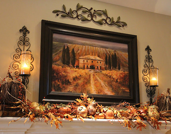 fireplace mantle serving as a fancy shelf for autumn decorations