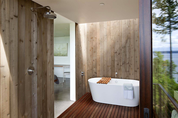 wooden bathroom with fancy bathtub