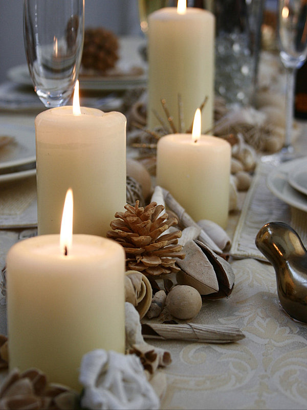 A Thanksgiving centerpiece of seed pods, candles and pine cones