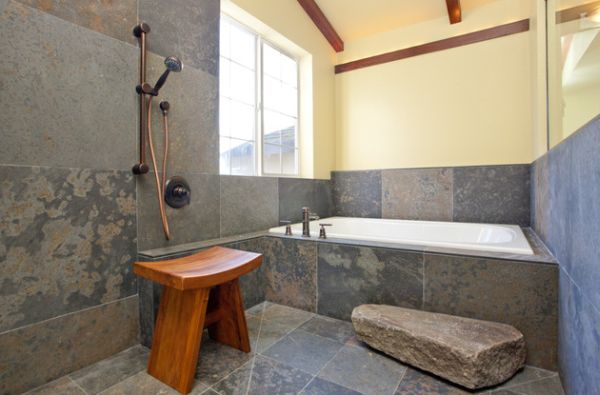 Classic Japanese bath design with simple teak stool and daft use of stone