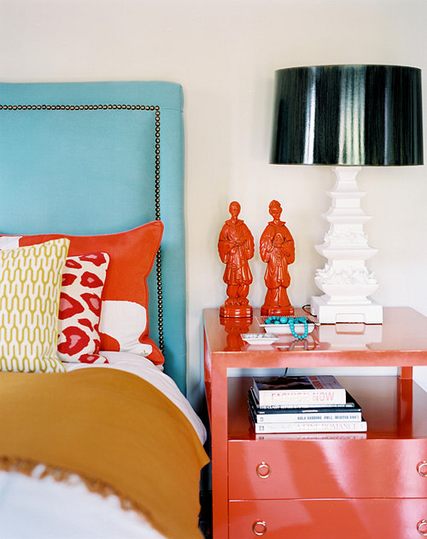 bedroom with turquoise headboard and red nightstand