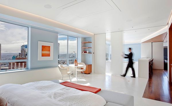 large bright bedroom with white orange and blue