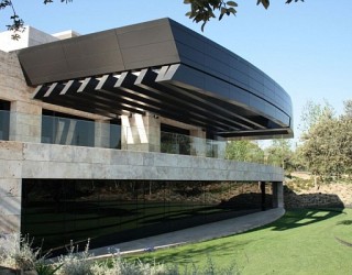 Spanish Home Clad in Dark Stone Assures Privacy and Serenity