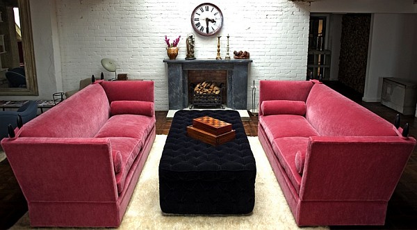 Stylish pink knole sofa adds color to a traditional living room