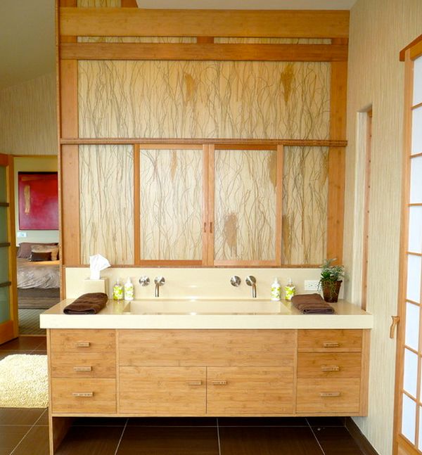 Artistic floating bathroom vanity draped extensively in light grain wood