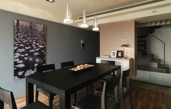 Beautiful dining room with heavy wooden table in dark colors