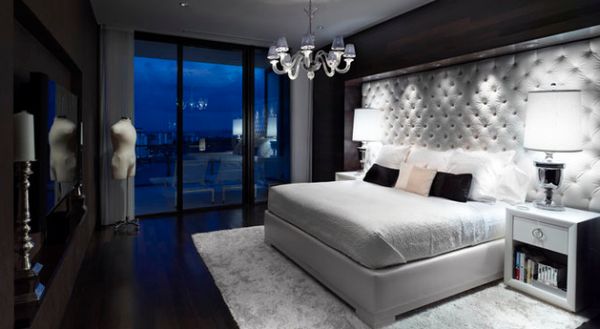 Custom designed tufted headboard covers almost an entire wall