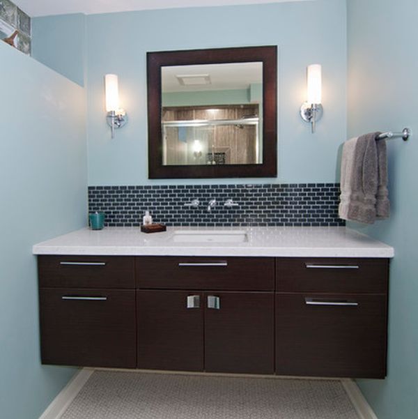 Dark floating cabinet with a white countertop and an undermount sink