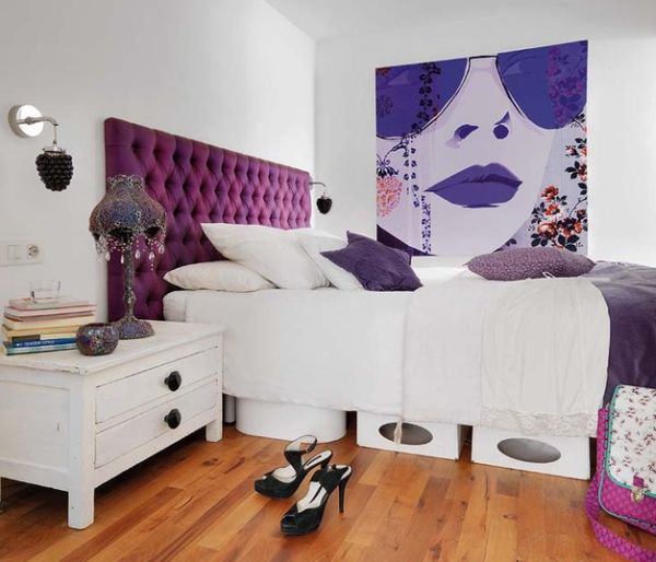 Fashionable apartment loft bedroom with bright purple tufted headboard