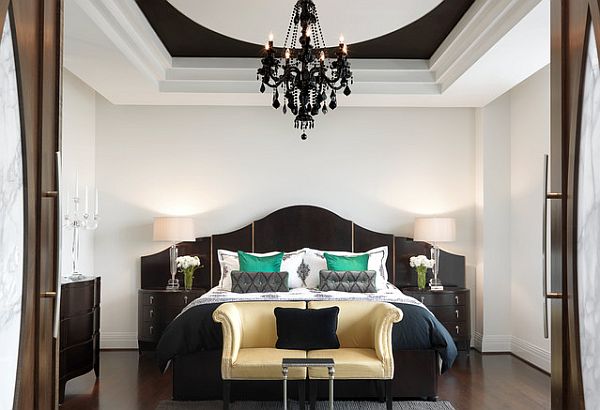 Luxury bedroom with emerald pillows to balance the neutral black and white