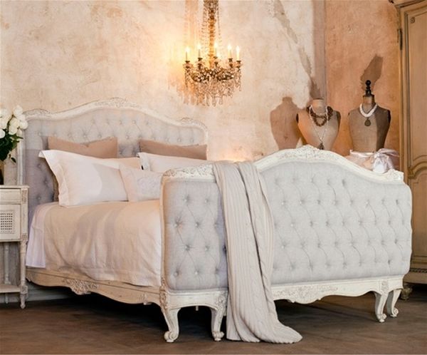 Serenely lit bedroom with raishing tufted headboard