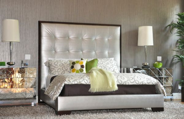 Silver upholstered bed with a tall tufted headboard