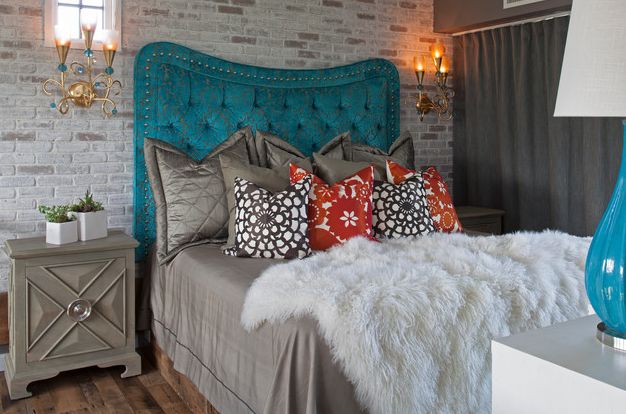 Stylish colorful headboard and cool brick wall make up a unique combination