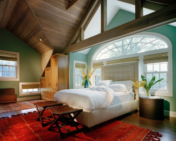 Tall tufted headboard keeps away the light from the beautiful windows behind the bed