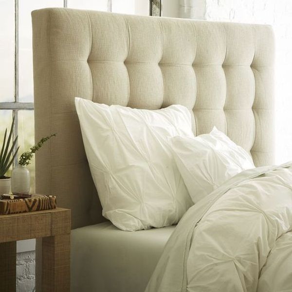 Unassuming tufted headboard in a soothing shade