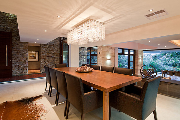 large dining area with modern furniture and stone walls