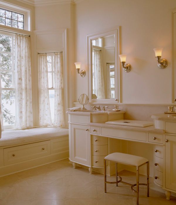 Ambient lighting and warm hues enhance the richness of this cream colored bathroom vanity