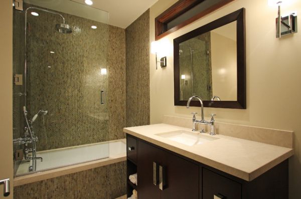 Beautiful modern bath that combines shower and the bathtub behind glass doors