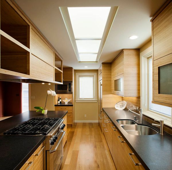 Dark countertops with light cabinets and smart skylights grace this savvy Asian kitchen