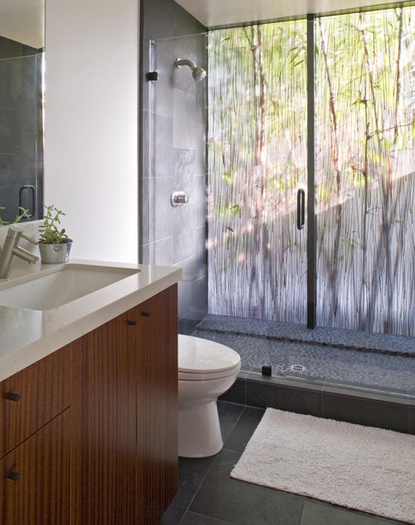 Dramatic bathroom with beautiful backlit rainforest-like acrylic panel and glass doors