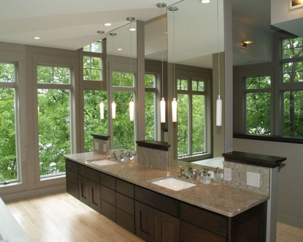 Floating vanity along with ampe use of glass give this master bath a spa-like feel