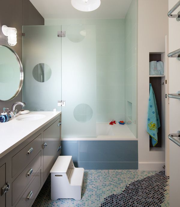 Imaginative transluscent glass enclosure creates a vibrant look in cool blue for the kids' bathroom