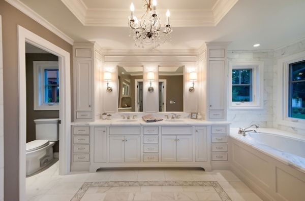 Marble flooring, chandeliers and tasteful cabinets make this bathroom truly indulgent