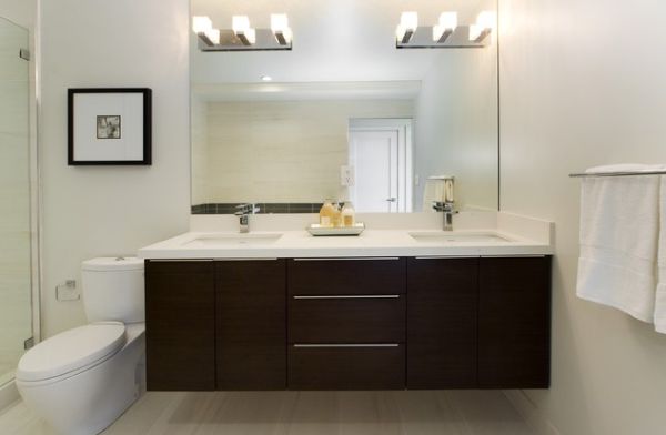 White countertop and dark cabinetry make this bathroom vanity stylish and beautiful