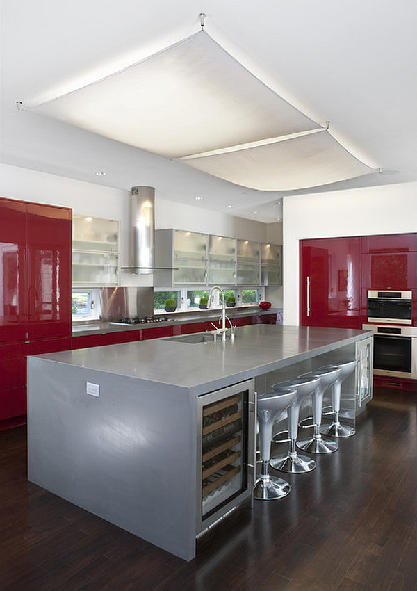 Glossy dark red cabinets and silver kitchen island